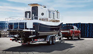2022 Nissan TITAN Truck towing boat | Clay Cooley Nissan Dallas in Dallas TX